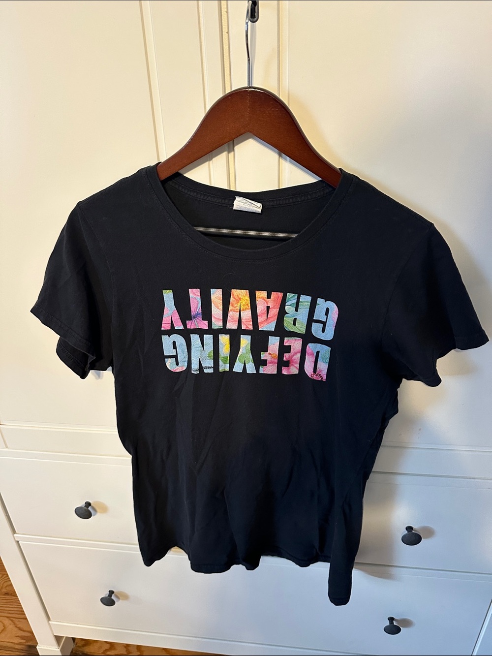 Black T-Shirt with Colorful 'Defying Gravity' Graphic